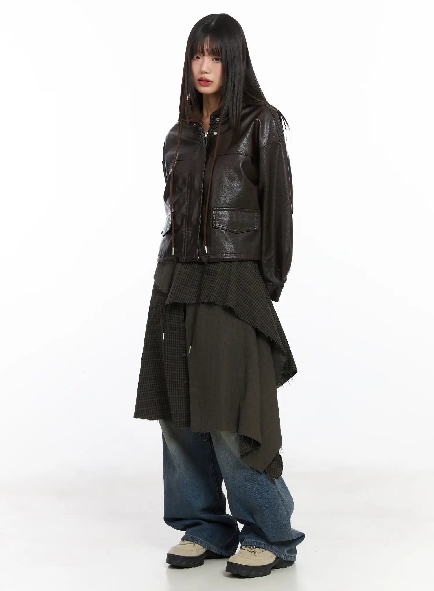 Miriam Wide Leg Jeans CD519 in blue, full-body 3/4 angle on model, styled under layered dark asymmetric skirt and brown faux-leather cropped jacket with chunky sneakers.