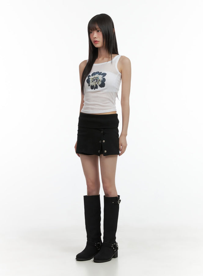 Floral Slim Camisole CO410 in light beige, full-length front view on model, slim sleeveless cami with dark floral graphic, styled with black mini skirt and knee-high boots.