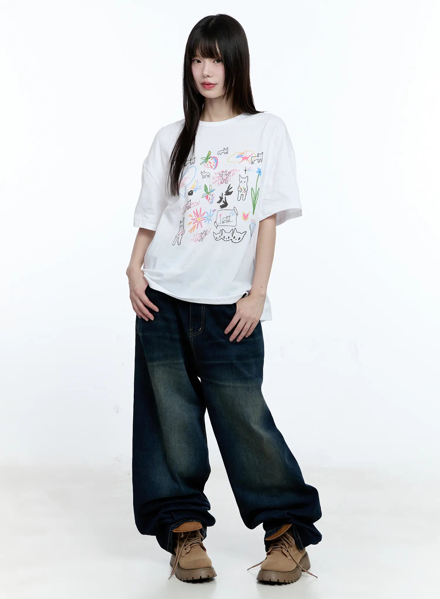 Jinnie Washed Wide-Leg Jeans CG511 in dark blue, full-body front shot on model, street-style outfit with white graphic tee and tan lace-up boots, relaxed wide-leg silhouette with washed finish.