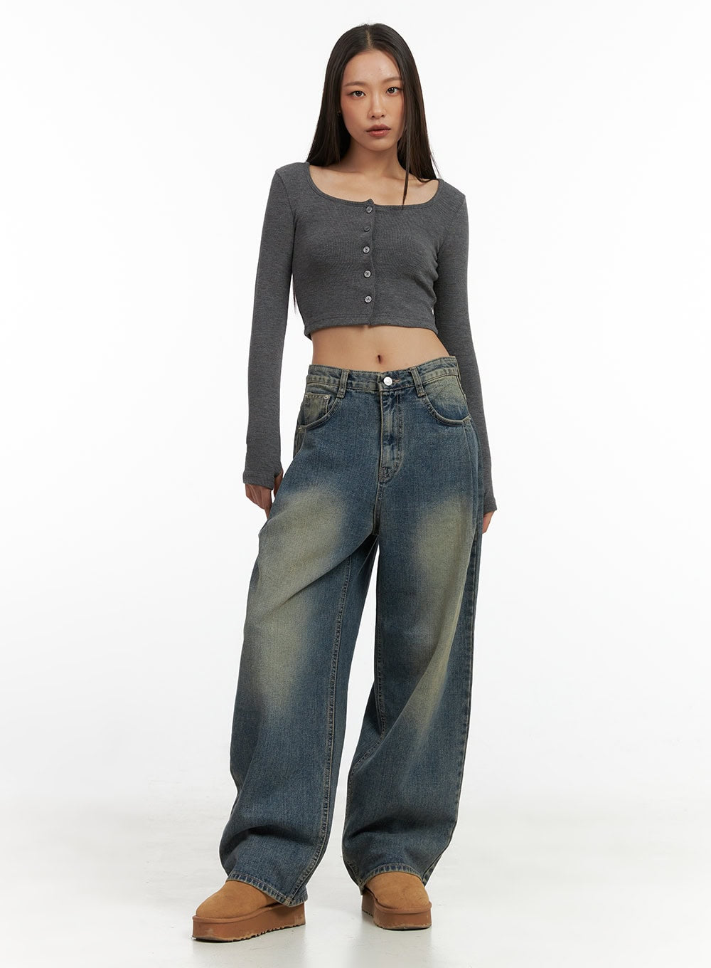 Peyton Pin-Tuck Washed Baggy Jeans CO424 in blue, full-body front shot on model, ultra-wide baggy silhouette with washed denim finish, styled with a grey cropped button top and tan boots.