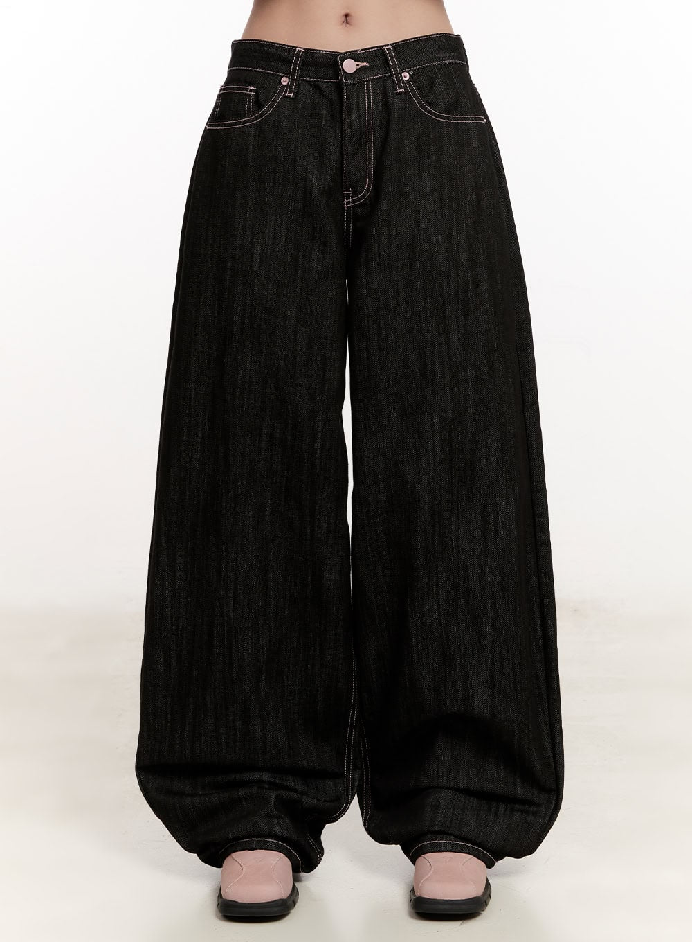 LEWKIN Trinity Stitched Baggy Jeans CM510 in black, front product shot on model, ultra-wide baggy cotton denim with contrast stitching, low rise, pooling hem, pink shoes.