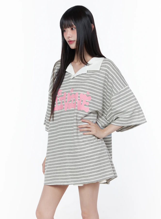 Oversized Stripe Graphic Tee CU519 in grey, three-quarter front view on model, open V-neck collar, pink graphic print on horizontal stripes, drop-shoulder short sleeves, worn alone as mini dress.