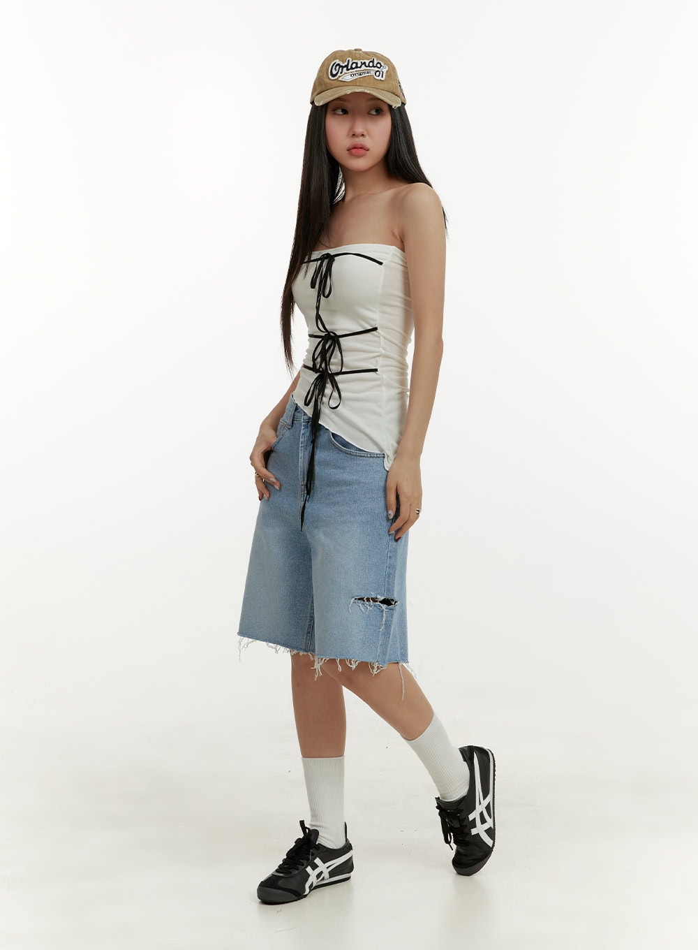 Straight Leg Jorts CY408 in blue, full-body side-angle shot on model, wide-fit destroyed denim jorts paired with white lace-up tube top, cap, white socks, and sneakers.