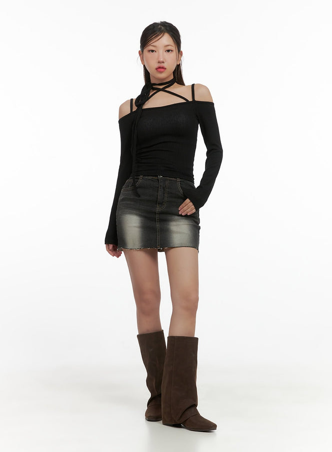 High Waist Double-Button Denim Mini Skirt CS405 in Black, full-body front shot on model, washed slim denim mini with raw hem, styled with black off-shoulder knit top and brown tall boots.