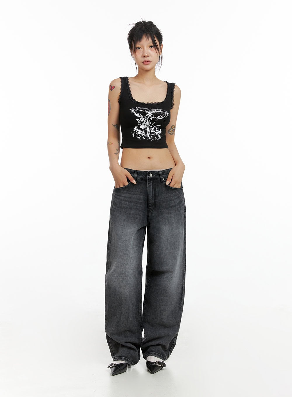 Low Rise Wide Leg Jeans CL415 in black, full-body front view on model, low-rise waist, wide leg cotton denim, styled with graphic lace-trim crop tank and buckle flats.