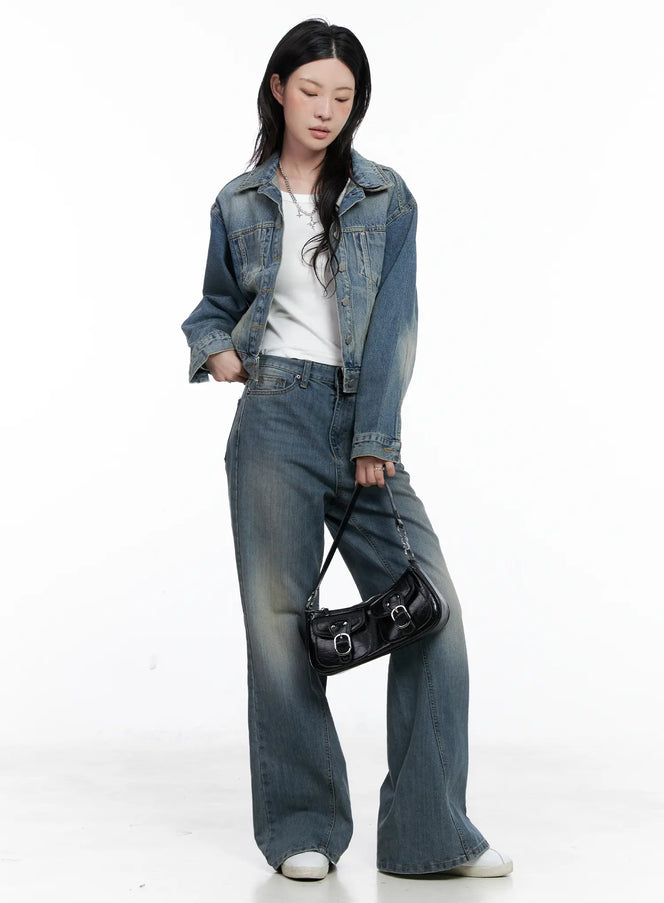 Aylin Wide Bootcut Jeans CS526 in blue, full-body front shot on model looking down, wide-fit washed denim with bootcut flare, styled with denim jacket, white tee, and black shoulder bag.