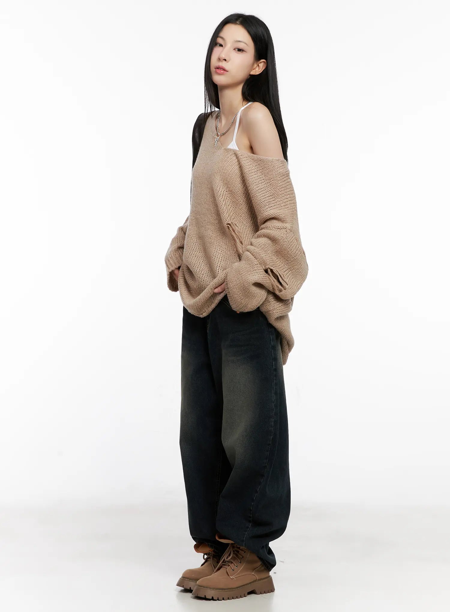 Hyer Washed Wide-Leg Jeans CG522 in dark blue, three-quarter side view on model, relaxed wide-leg silhouette with washed fade, styled with oversized beige knit sweater and tan lug-sole boots.