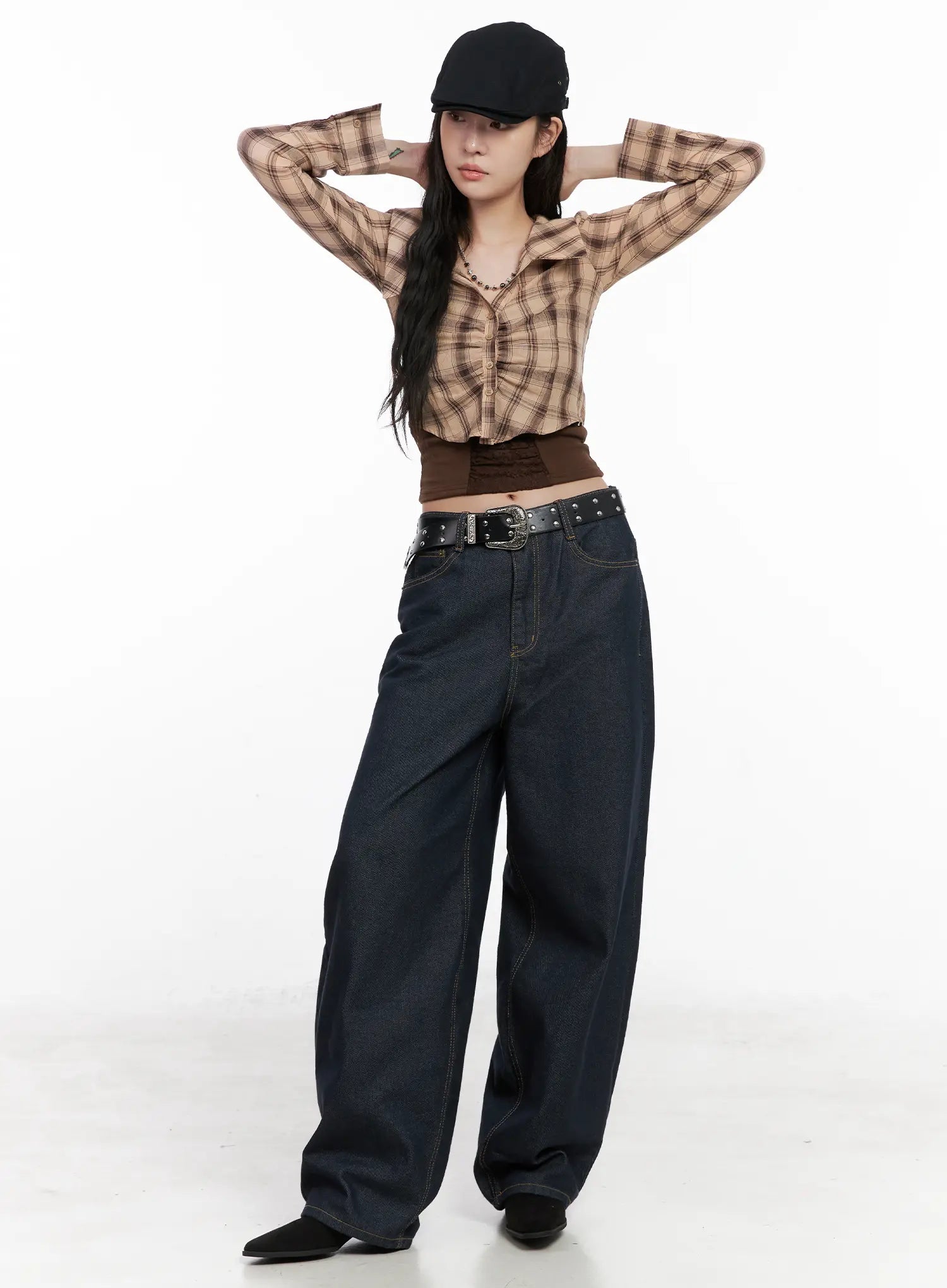 Heaven Wide-Leg Dark Washed Jeans CN513 in dark blue, full-body front shot on model, arms raised, styled with plaid crop shirt, brown top, and studded belt.