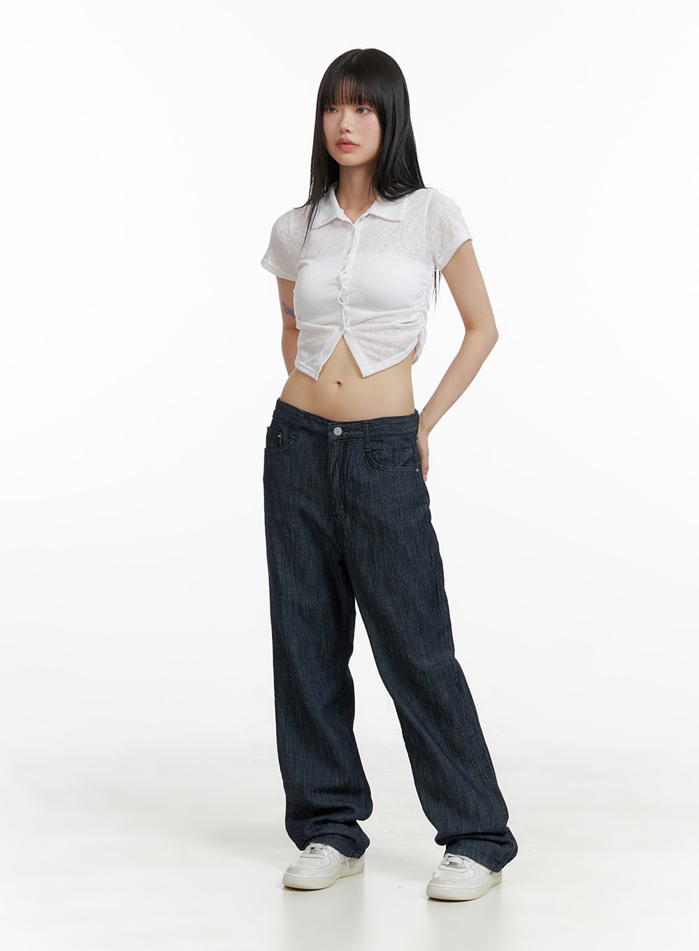 Low Waist Loose Fit Baggy Jeans CL403 in dark blue, full-body front shot on model, wide baggy leg silhouette, styled with white sheer crop polo top and white sneakers.