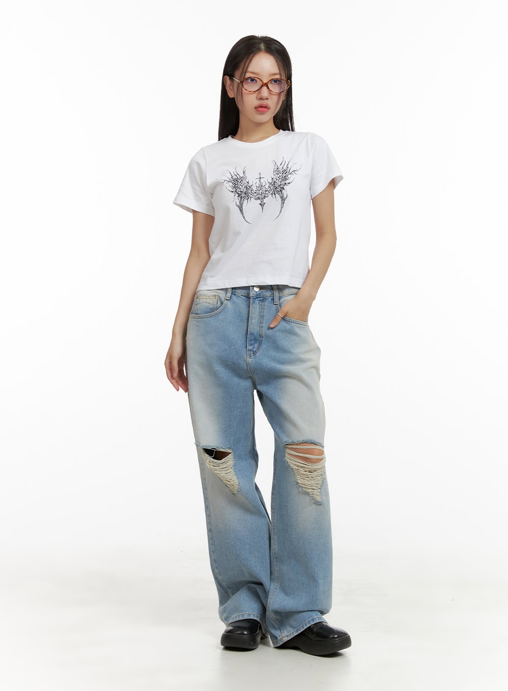 Urban Washed Ripped Baggy Jeans CU405 in Blue, full-body front on model, street-style wide-leg silhouette with ripped knees, styled with a white graphic crop tee and black chunky loafers.