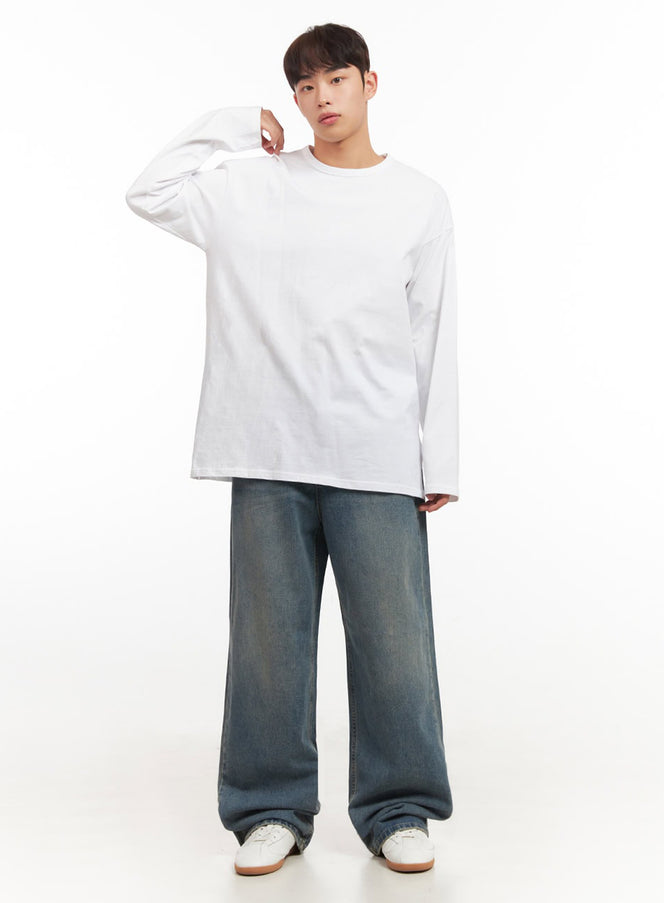 Men's Essential Oversized Long-Sleeve T-Shirt IF517 in white, full-body front shot on model, relaxed oversized silhouette, arm raised, styled with wide-leg denim and white sneakers.