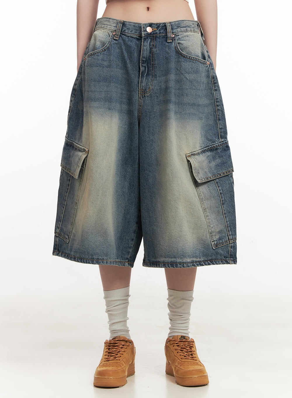 LEWKIN Cargo Bermuda Denim Shorts CF514 in dark blue, front view on model, wide-fit washed cotton denim with flap cargo pockets, midi length, styled with white socks and tan sneakers.