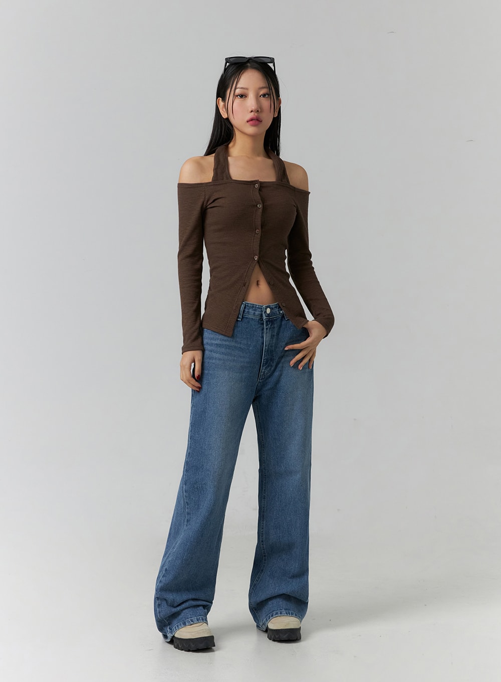 Wide Leg Jeans J12 in blue, front full-body shot on model, relaxed wide-fit cotton denim with subtle gradation, slightly loose stance, styled with brown off-shoulder cardigan top.