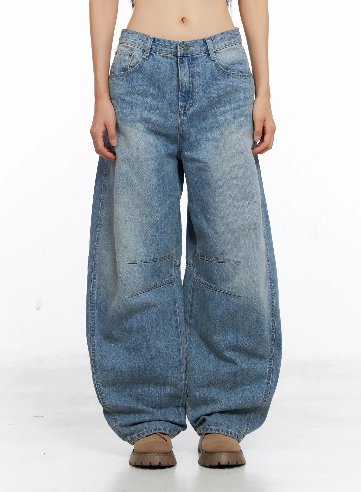 Dakota Relaxed Fit Vintage Wash Jeans CS511 in blue, front waist-to-hem product shot on model, oversized wide-leg silhouette with knee stitch detail and vintage fade, worn with tan chunky boots.