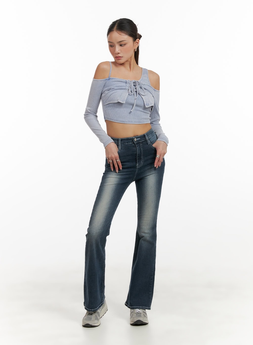 Washed Denim Slim Fit Bootcut Jeans CY402 in blue, full-length front three-quarter view on model, washed indigo denim, slim fit through hips, gentle bootcut flare, styled with crop top.