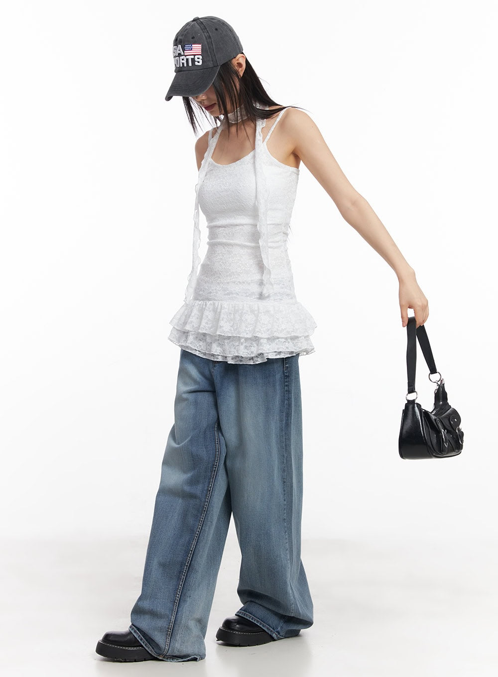 Pauline Wide-Leg Baggy Jeans CY512 in blue, full-length editorial shot on model, wide-leg washed denim, styled with white lace cami, cap, and mini bag.