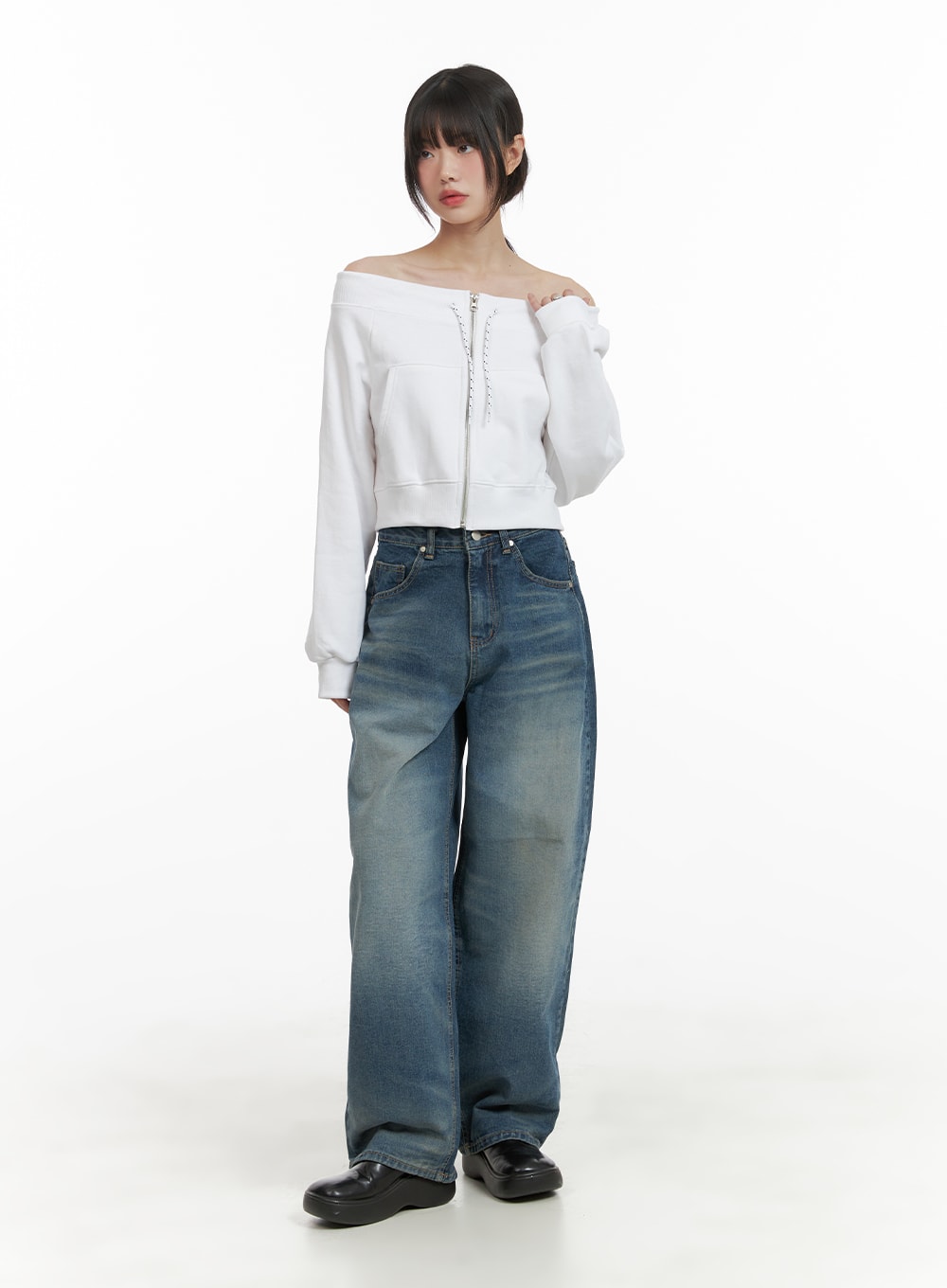 Washed Wide Leg Jeans CA419 in blue, full-body front shot on model, relaxed wide-leg silhouette with washed denim, styled with white off-shoulder zip crop top and black loafers.