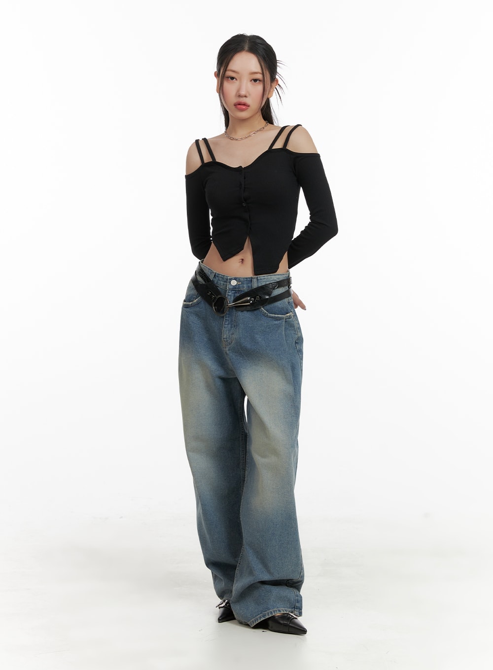 Washed Out Wide Fit Baggy Jeans CA416 in blue, full-body front shot on model, relaxed wide-leg silhouette with faded wash, paired with black off-shoulder crop top and belt.