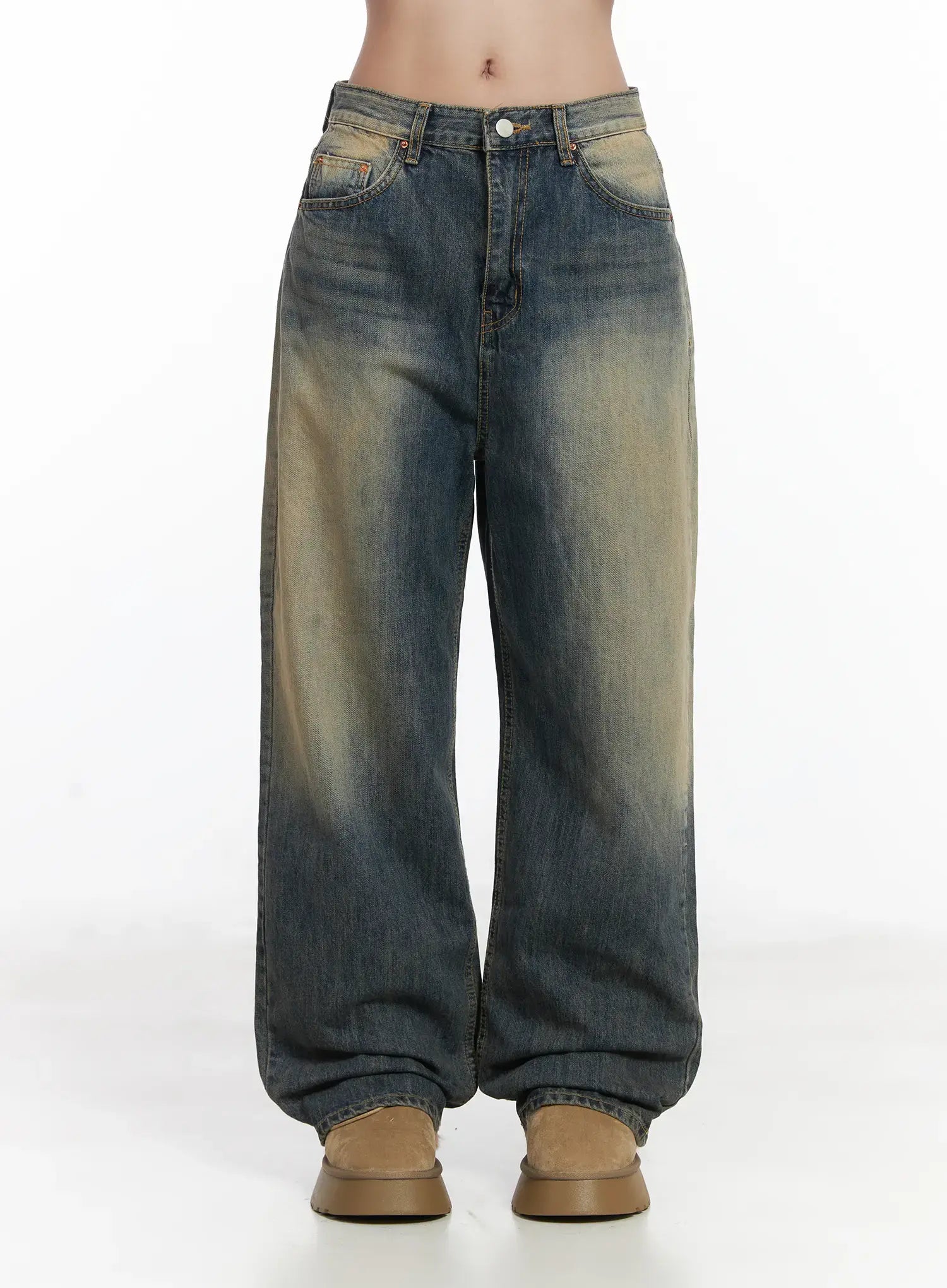 LEWKIN Wide Washed Jeans CS06 in vintage blue, front view on model, wide-leg cotton denim with sandy yellow wash fading, 5-pocket styling, stacked hem, paired with tan boots.