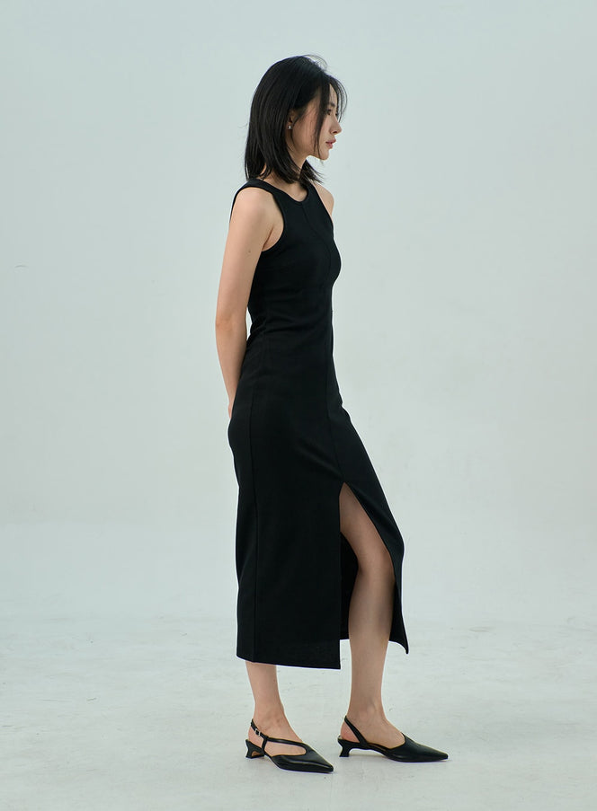 Slit Sleeveless Maxi Dress OY310 in black, side profile full-body on model, front slit hem visible, sleeveless slim silhouette, paired with black slingback mules.
