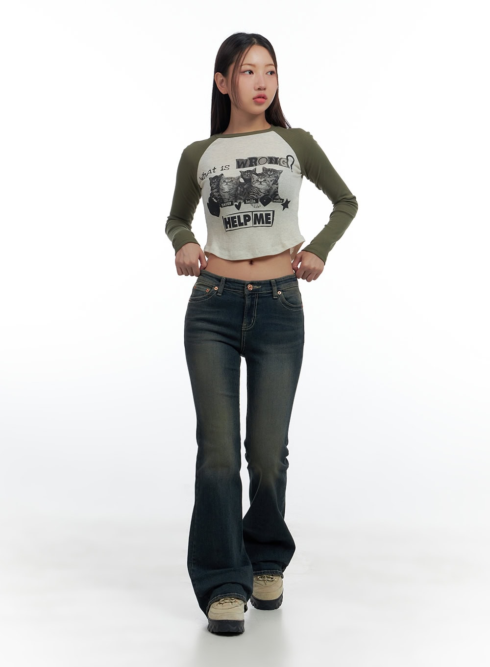 Aspen SlimFit Washed Bootcut Denim Jeans CS424 in dark blue, full-body front shot on model walking, tall length bootcut silhouette, styled with a green raglan crop top and chunky boots.