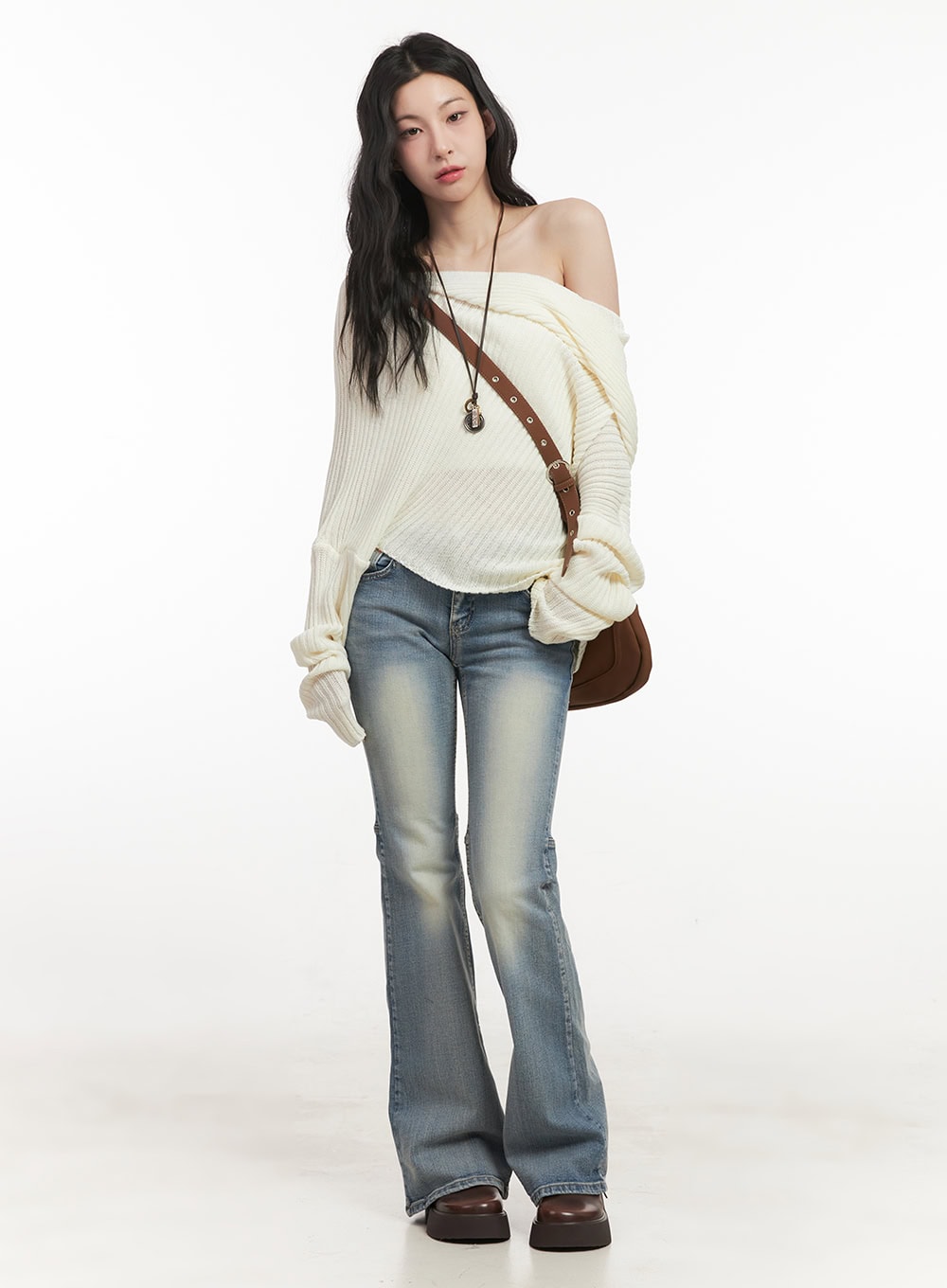 Tracy Washed Bootcut Jeans CF513 in light blue, full-body front styling shot on model, paired with cream off-shoulder ribbed knit sweater and brown crossbody bag.