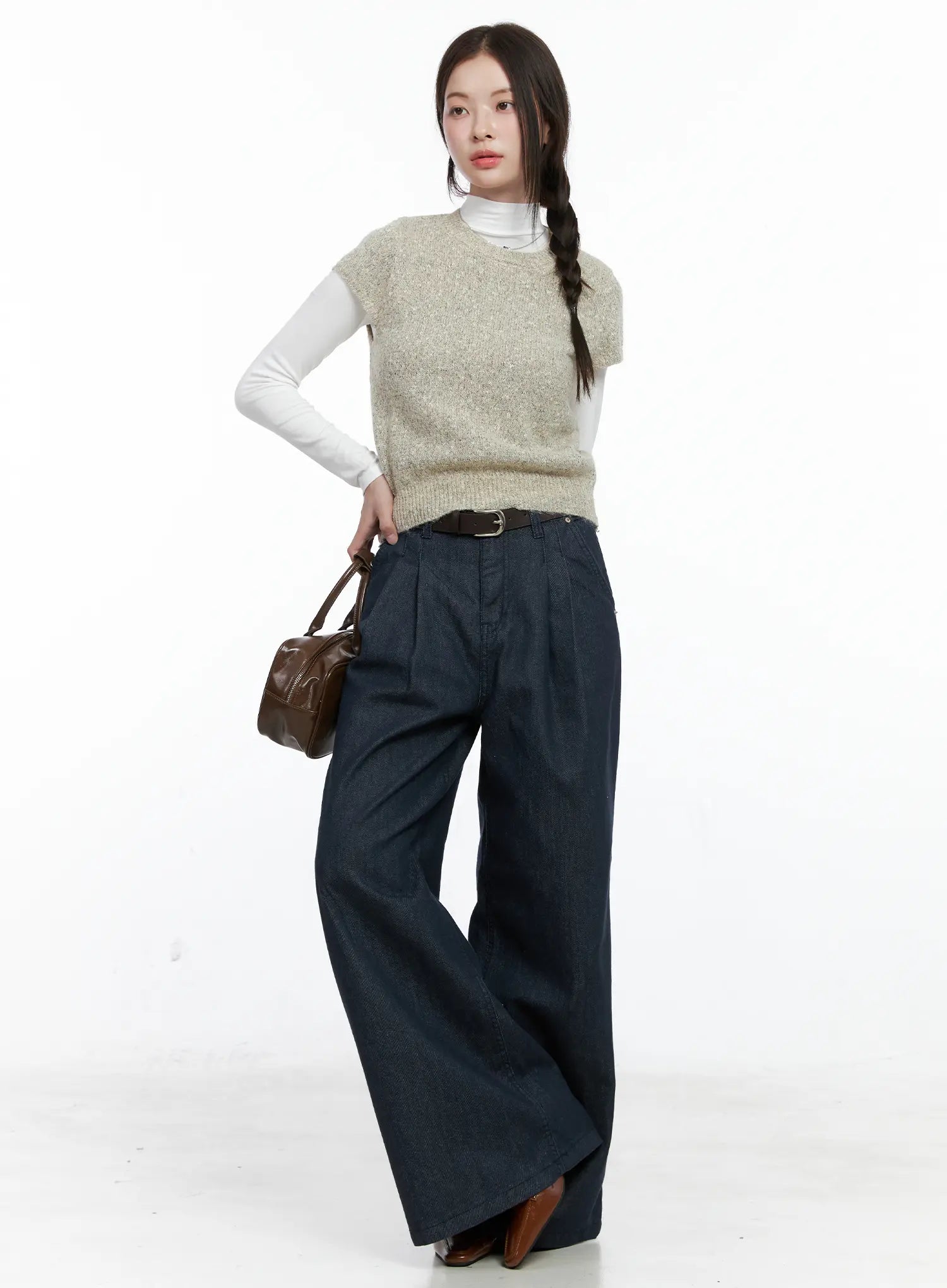 Lena Pintuck Baggy Jeans CO503 in dark blue, full-body front shot on model, wide-fit long denim paired with beige knit vest, white turtleneck, brown belt, and brown leather bag.