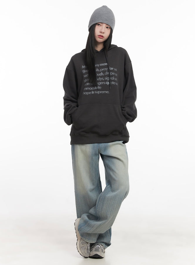 Nicola Washed Wide-Leg Jeans CF514 in light blue, full-body front on model, relaxed wide-leg denim styled with oversized graphic hoodie and grey beanie, street look.