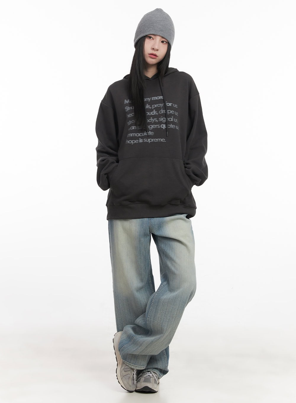 Nicola Washed Wide-Leg Jeans CF514 in light blue, full-body front on model, relaxed wide-leg denim styled with oversized graphic hoodie and grey beanie, street look.