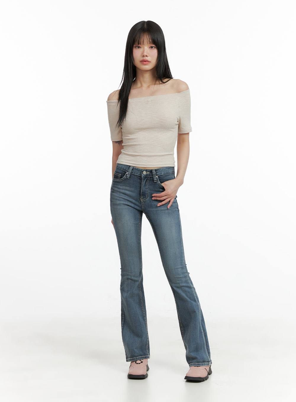 Tight Fit Low Waist Bootcut Jeans CL403 in dark blue, full-body front shot on model, tight fit with bootcut flare, styled with off-shoulder beige ribbed crop top and pink flats.