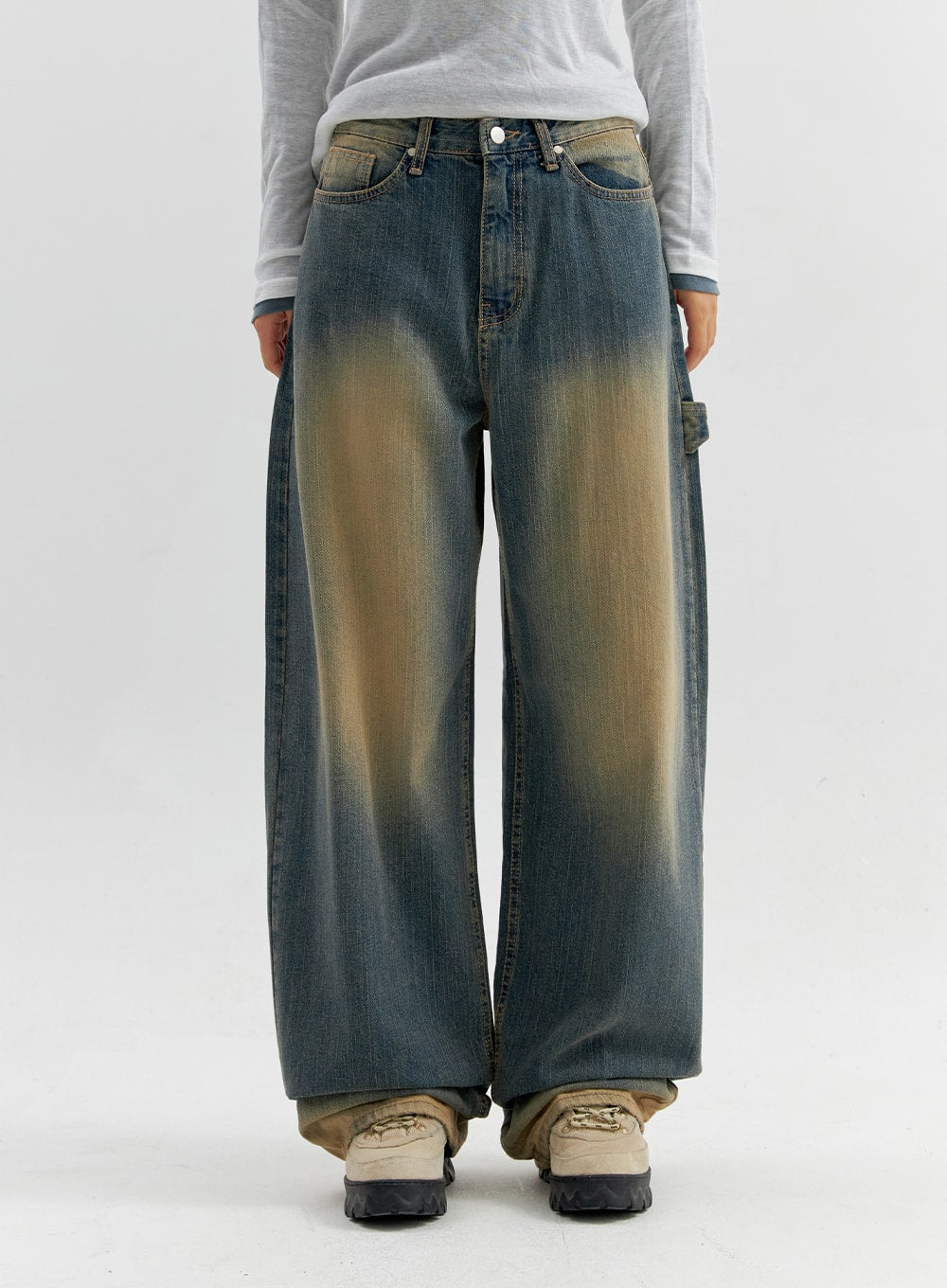 Vintage Wash Wide Leg Jeans CO306 in blue, front crop shot on model, wide-fit denim with heavy yellow sun-fade at thighs, five-pocket silhouette, paired with gray long sleeve.