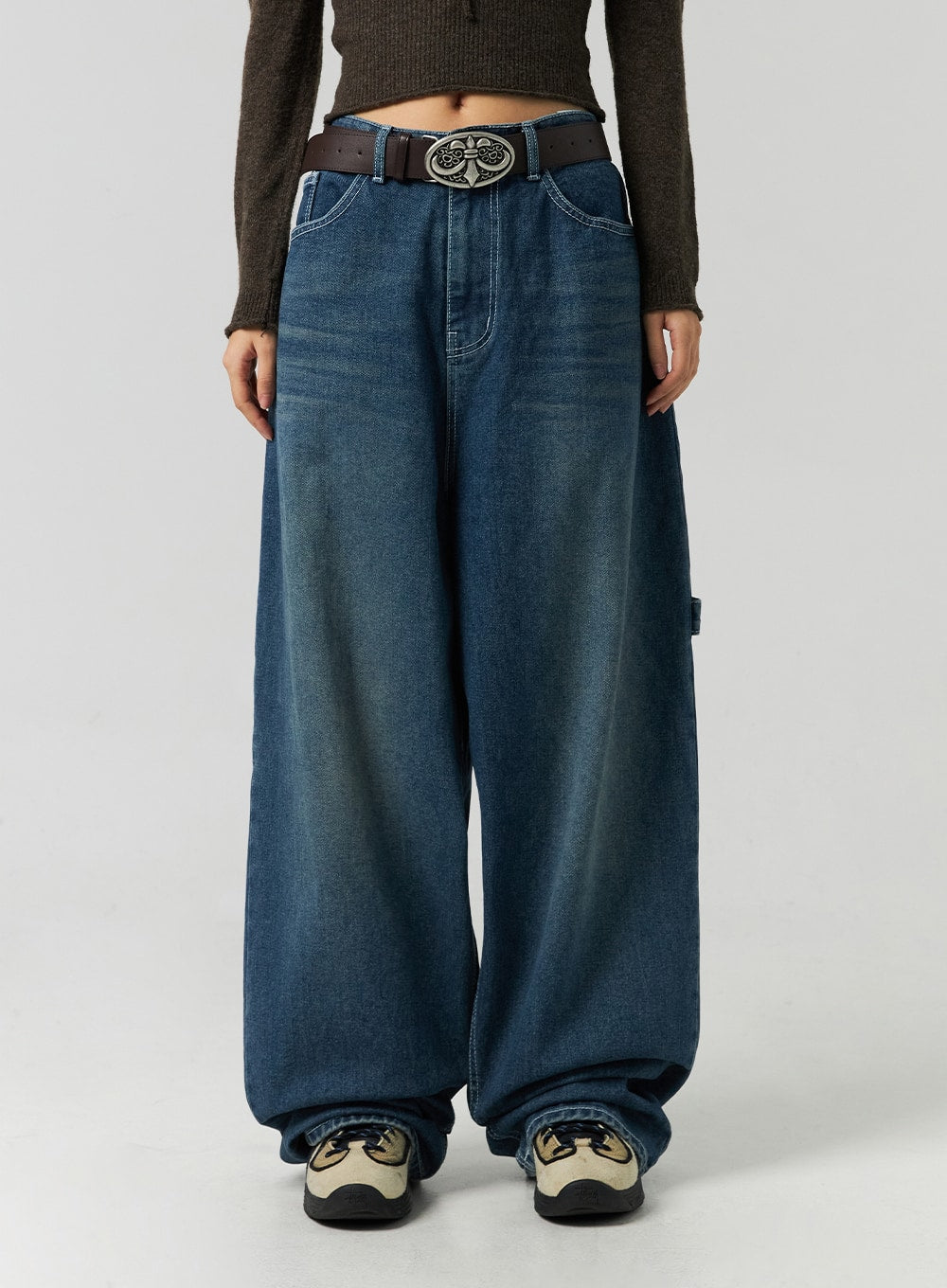 Washed Cotton Wide Leg Jeans CO323 in blue, front waist-to-hem close-up on model, high-rise washed denim with contrast stitching and ornate belt, extra-wide leg pooling at sneakers.