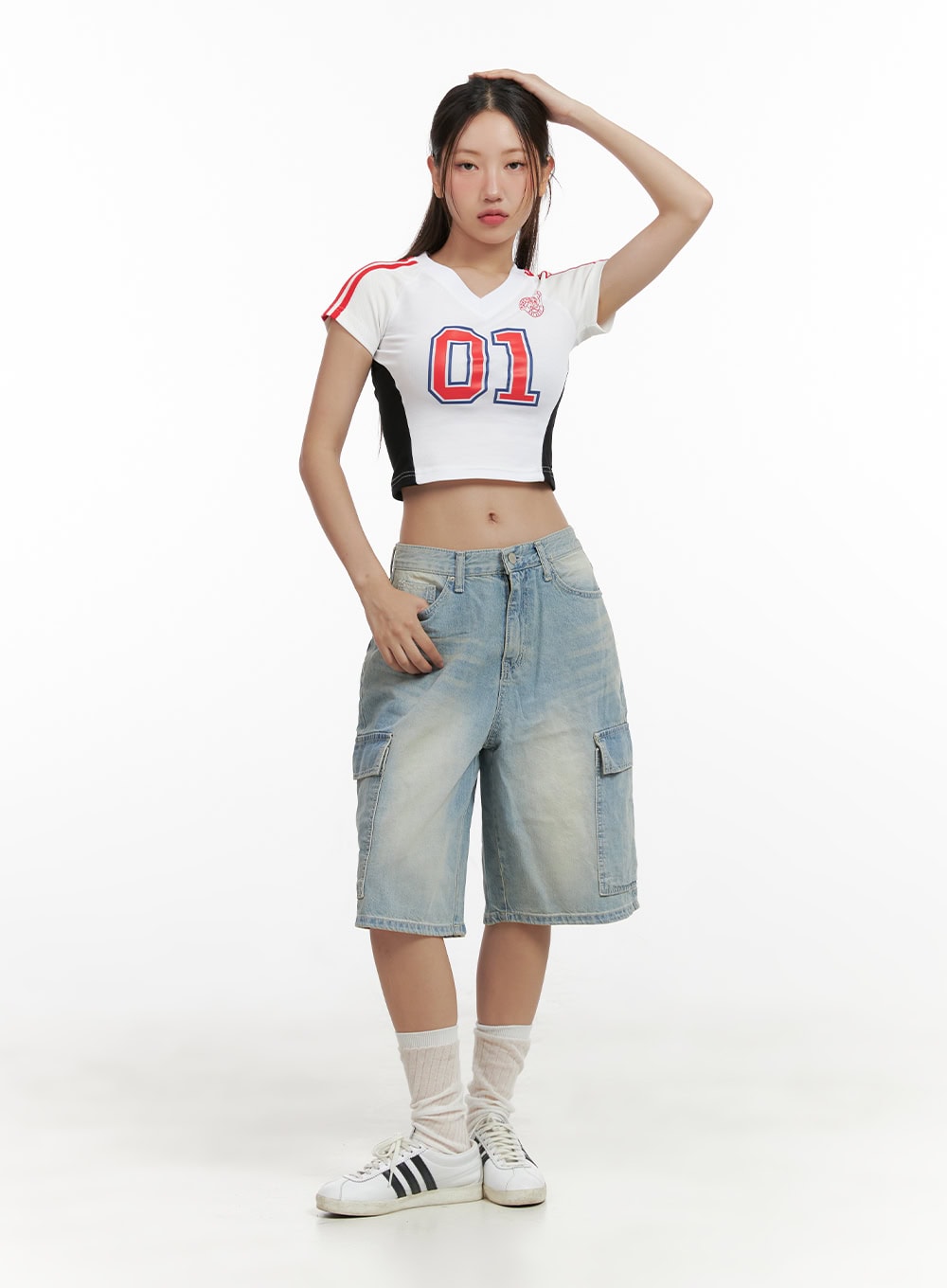 Cargo Baggy Jorts CL431 in light blue, full-body front shot on model, baggy washed denim shorts styled with a cropped sports jersey and white sneakers.