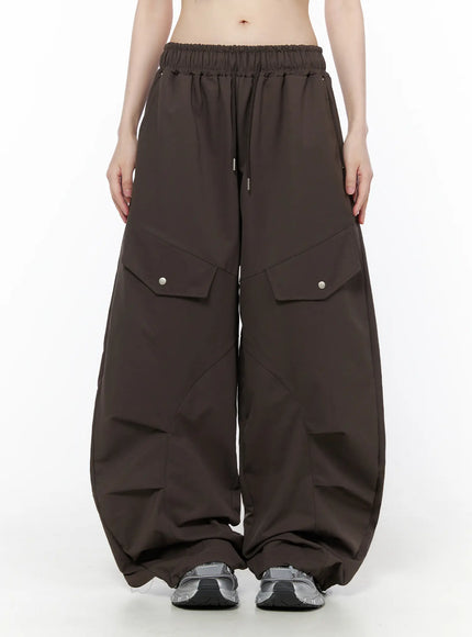 Wide Leg Pintuck Cargo Pants CU519 in dark brown, front full-length product shot on model, elastic drawstring waist, snap-button cargo pockets, voluminous gathered hem.