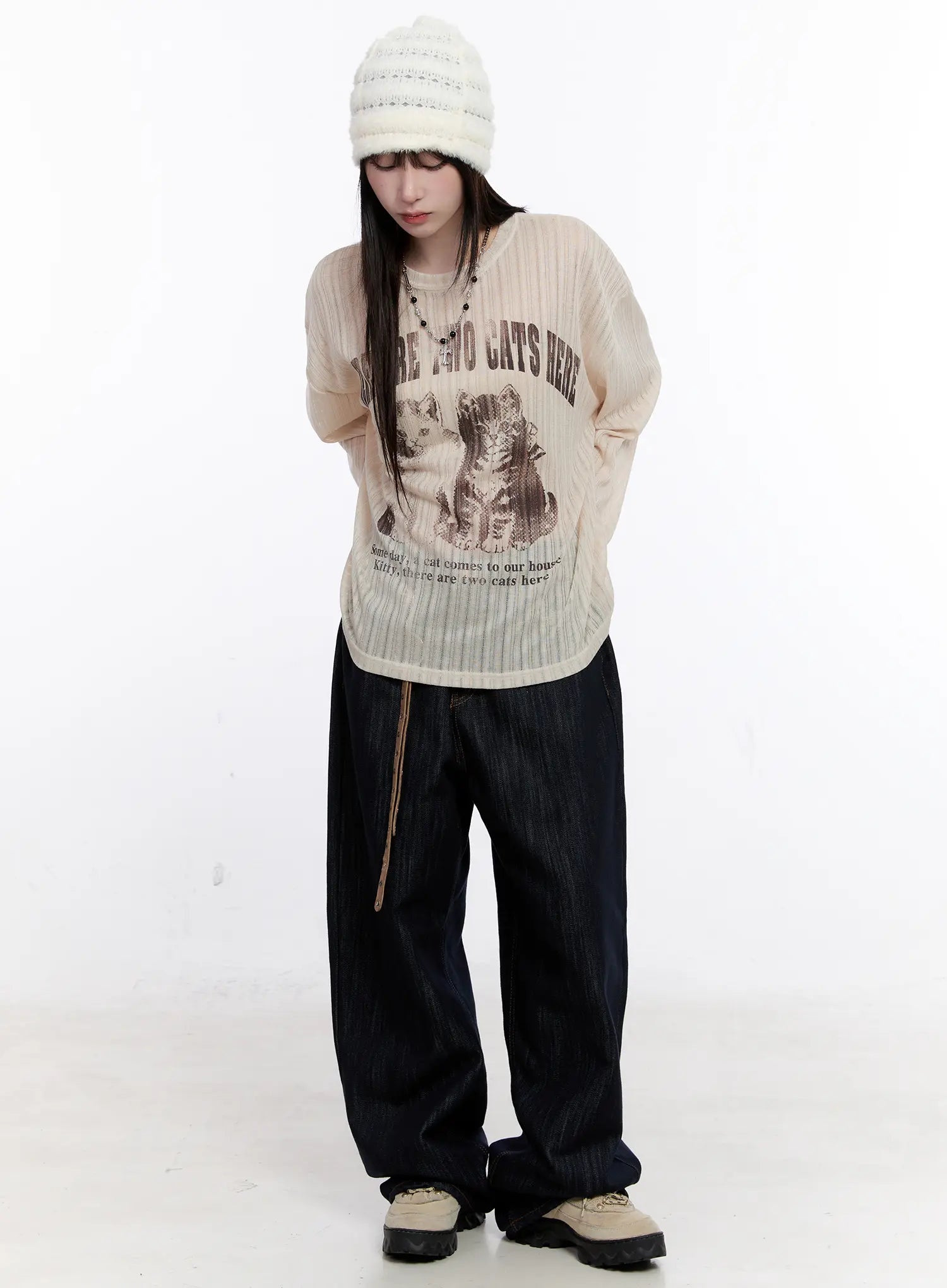 Haewon Dark Washed Baggy Jeans CS530 in dark blue, full-body front shot on model, styled with cream graphic long-sleeve top and white beanie, ultra-wide leg pooling at ankle.