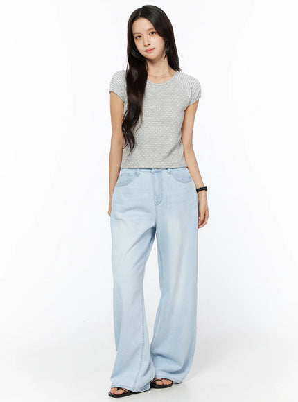 Rina Washed Wide-Leg Jeans CU522 in light blue, full-body front on model, floor-length wide leg, styled with grey dotted crop tee and black sandals.