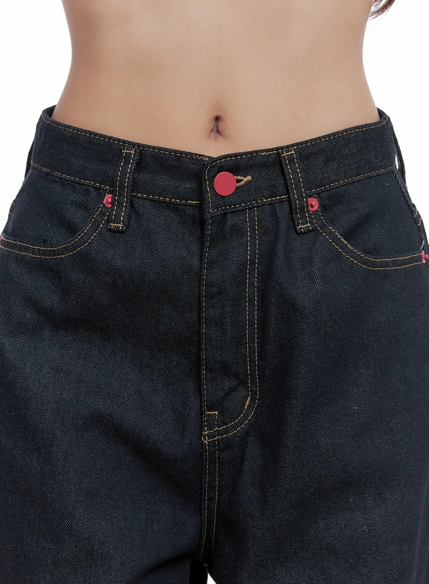 Heart Pocket Balloon Jeans CS503 in dark indigo, front waistband close-up, red button closure and rivets, yellow contrast topstitching, five-pocket construction on model.
