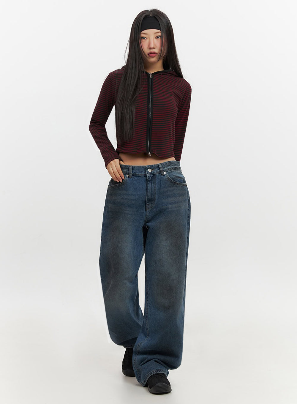 Brianna Dark Washed Wide-Leg Jeans IF510 in dark washed blue, full-body front on model mid-stride, wide-fit baggy denim with dark wash fade, styled with red striped crop hoodie and black sneakers.