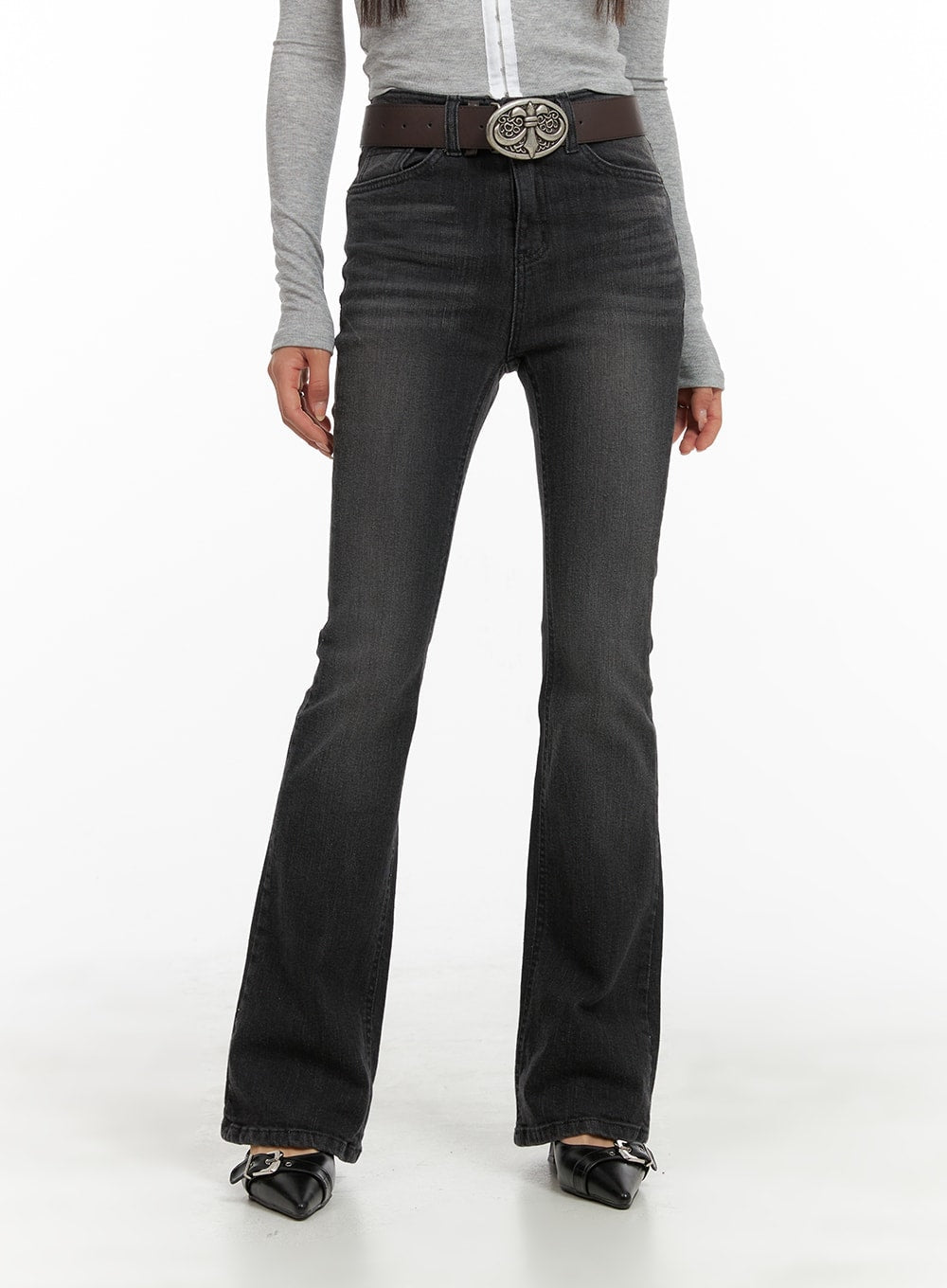 Slim Washed Denim Bootcut Jeans CA403 in black, front mid-body shot on model, washed slim fit with subtle bootcut flare from knee, worn with ornate oval belt buckle.