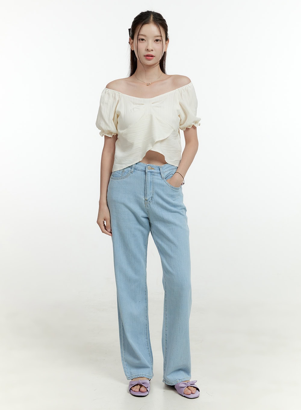 Ava Light Washed Straight Jeans OL430 in light blue, front full-length shot on model facing camera, wide-fit straight leg with light washed denim, hand in pocket, styled with ivory off-shoulder top.
