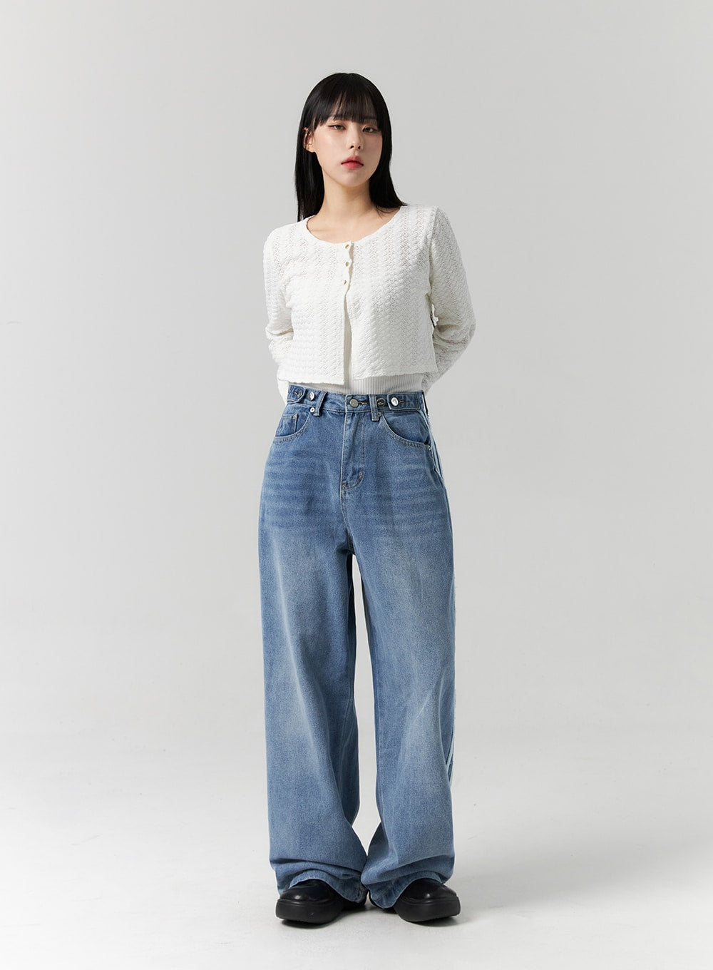 Side Stripes Wide Leg Jeans CS314 in blue, full-length slightly angled front shot on model, high-rise washed denim wide leg, styled with white cropped knit cardigan and black platform shoes.