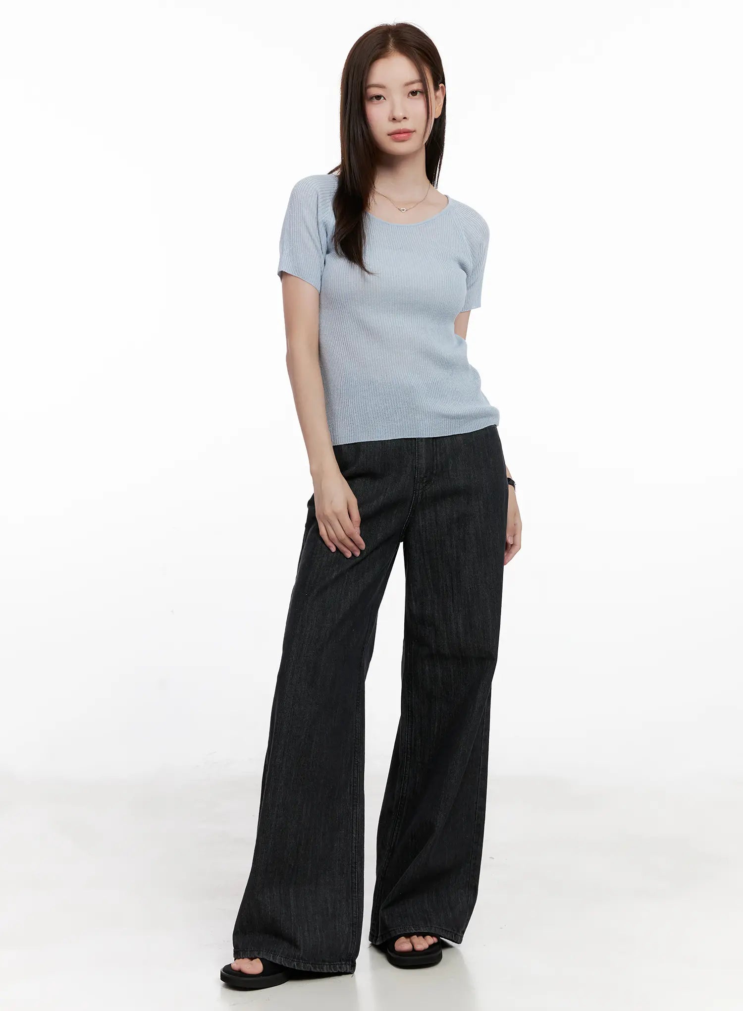 Yeon High-Waist Wide Jeans CL523 in black, three-quarter front view on model in light blue ribbed top, wide-leg floor-length cotton denim, hands at sides.