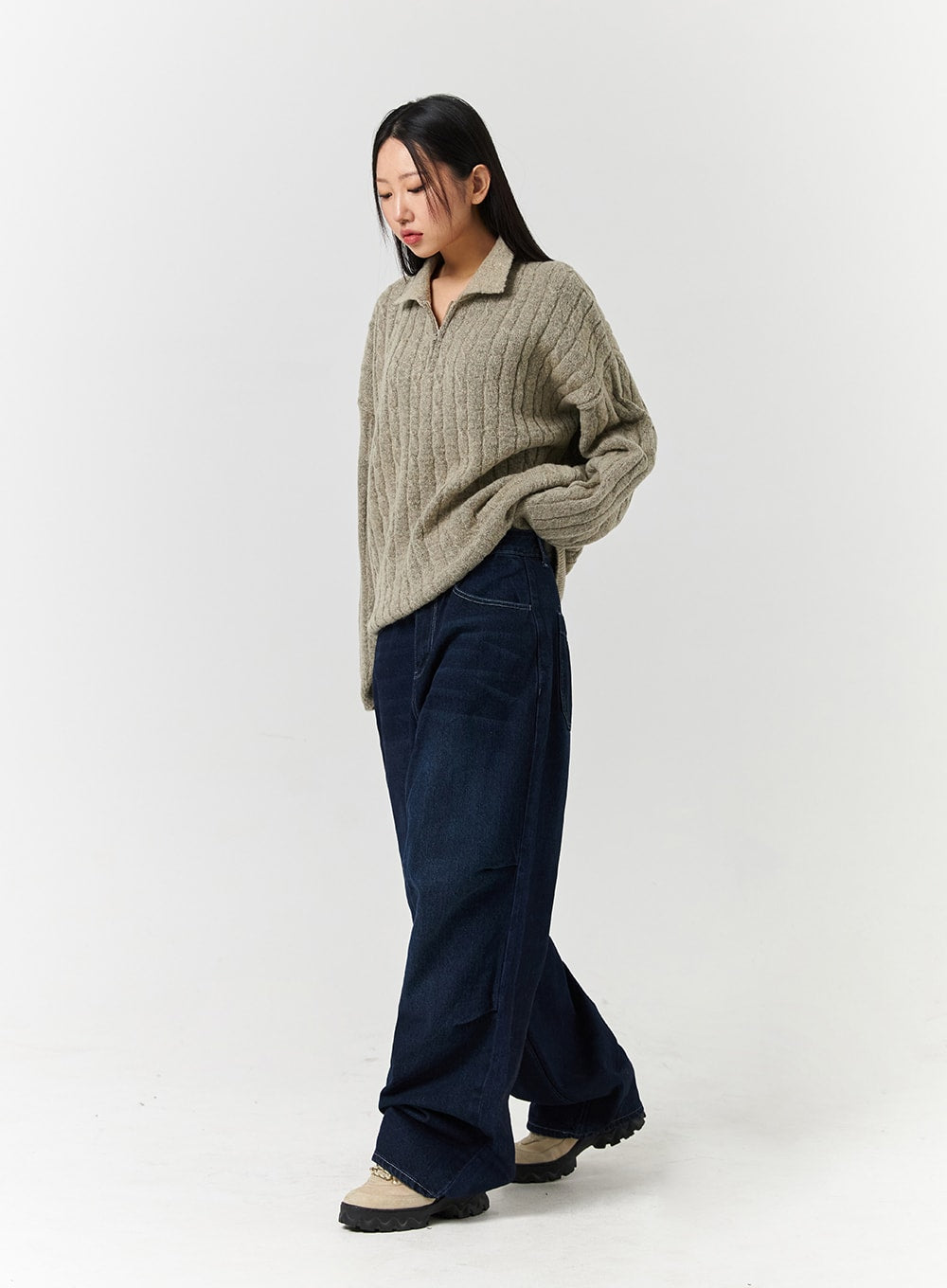 Unisex High Waist Solid Pocket Straight Leg Jeans CD328 in Blue, side-angle full-length shot on model walking, wide straight-leg silhouette in dark washed cotton denim, paired with beige half-zip knit.