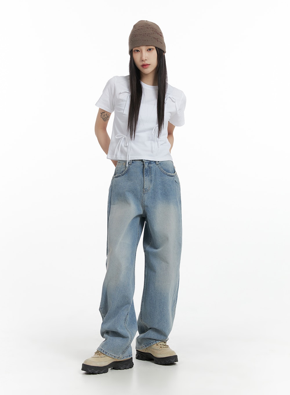 Wide Leg Baggy Jeans CM405 in light blue wash, full-body front shot on model, oversized wide-leg silhouette styled with white drawstring crop tee, brown beanie, and chunky sneakers.