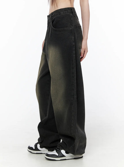 Bodie Vintage Wash Wide Leg Jeans CU519 in black, side view on model, vintage khaki fade wash, oversized wide leg with side seam detail, cropped midriff, paired with sneakers.