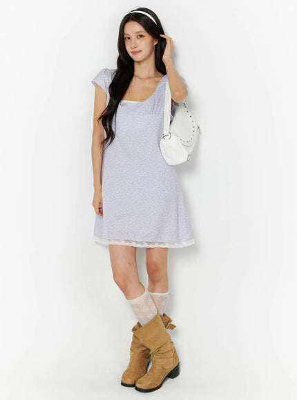 Romantic Floral Lace Trim Mini Dress CU522 in light purple, full-body front view on model, A-line silhouette with lace trim hem, paired with tan boots and lace socks, white shoulder bag.
