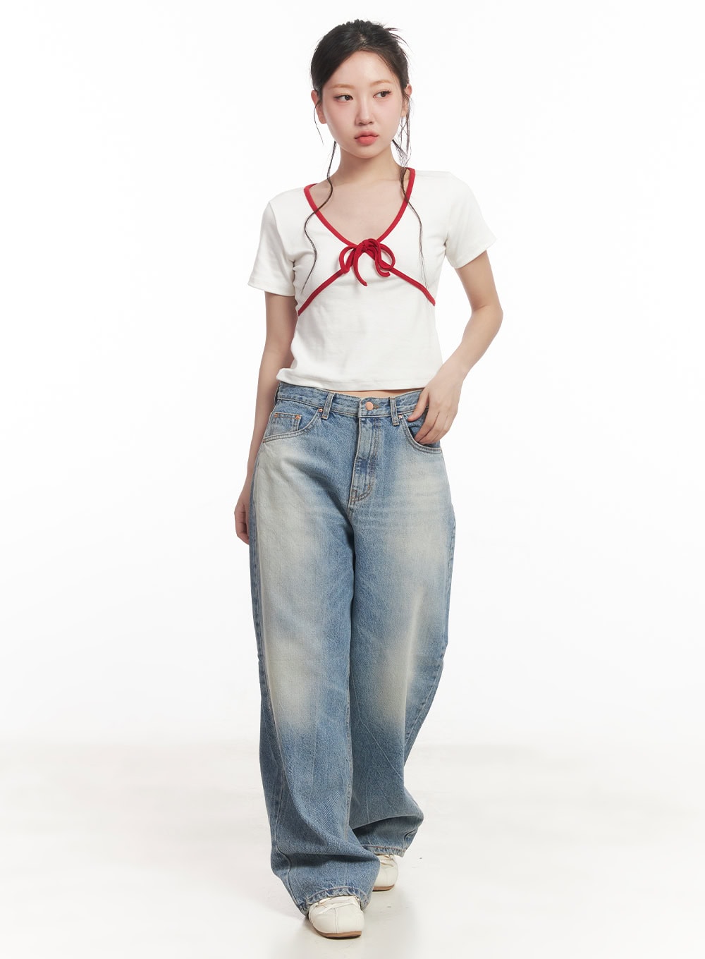 Lumira Back-Detail Washed Wide Leg Jeans CA530 in blue, full-length front view on model, wide-fit washed denim, paired with white red-bow crop tee and white sneakers.