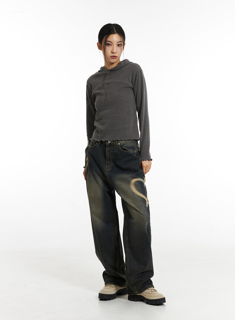 Heart-Bleached Wide Leg Jeans IN308 in dark blue, front full-body shot on model standing straight, relaxed wide-leg silhouette with bleached heart motif, styled with grey hoodie and beige sneakers.