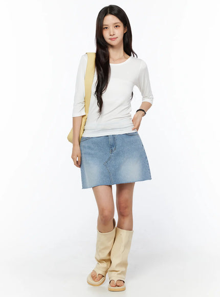 Sheer Three-Quarter Sleeve Top CU522 in white, full-length front shot on model, slim silhouette with three-quarter sleeves, paired with denim mini skirt and beige knee-high sandal boots.