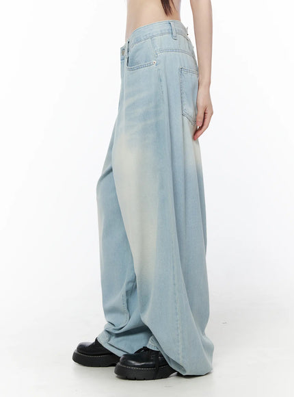 Ozzy Washed Wide Leg Jeans CU519 in light blue, side view on model, extreme wide leg with sun-faded wash, low-rise waist and voluminous drape to floor.